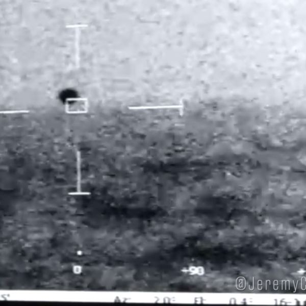 Grainy footage of a UAP is shown.