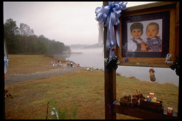 Toys and pictures of Michael and Alex Smith at the John D. Long Lake shore shrine.