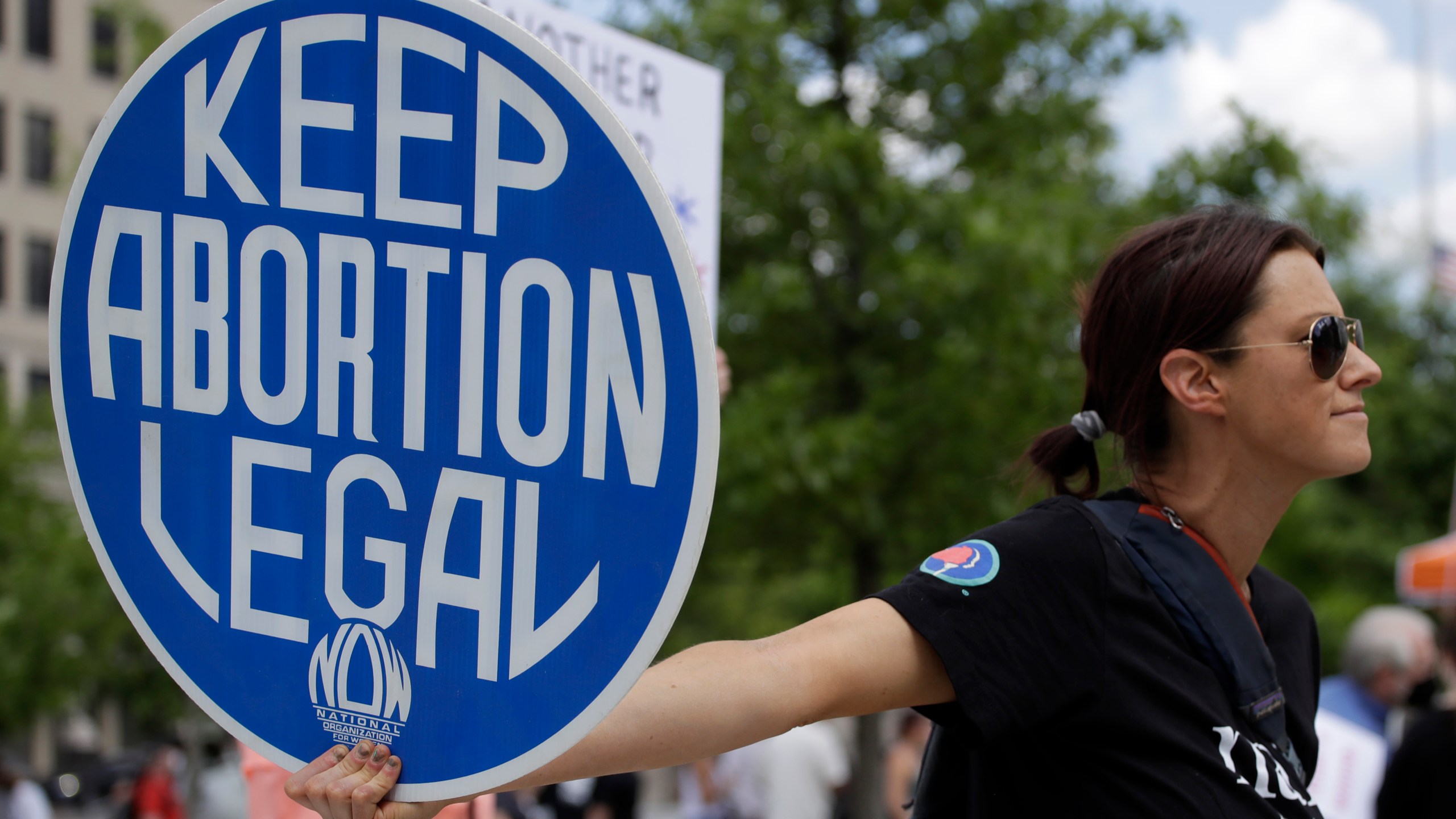 FILE - An. Abortion rights demonstrator holds a sign during a rally on May 14, 2022, in Chattanooga, Tenn. Women in Idaho, Tennessee and Oklahoma are challenging strict abortion laws that went into effect after the Supreme Court overturned Roe v. Wade last year. Two state lawsuits were filed on Tuesday, Sept. 12, 2023, in Idaho and Tennessee after women were denied care while facing harrowing pregnancy complications. Meanwhile, a federal complaint was filed in Oklahoma after a woman couldn't receive an abortion despite having a dangerous and nonviable pregnancy. (AP Photo/Ben Margot, File)