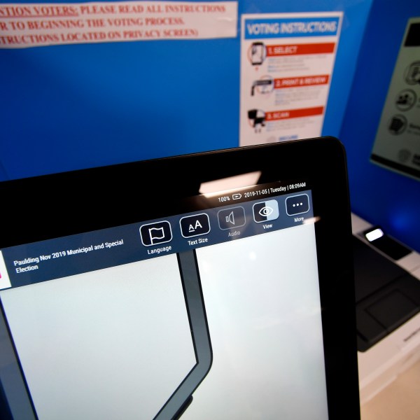 A touchscreen voting machine and printer are seen in a voting booth, in Paulding, Ga. on Nov. 5, 2019.