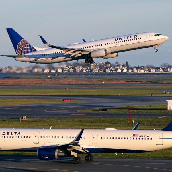 A United Airlines jet takes off while a Delta Airlines plane taxis at Logan International Airport, Monday, Nov. 21, 2022, in Boston.