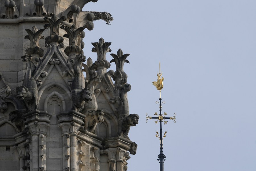 The cross and the rooster atop the Notre Dame de Paris cathedral spire, Thursday, March 14, 2024 in Paris. Scaffolding has enshrouded Notre Dame Cathedral in Paris since a 2019 fire destroyed its spire and roof and threatened to collapse the whole medieval structure. After an unprecedented international reconstruction effort, the scaffolding is at last starting to peel away. (AP Photo/Michel Euler)