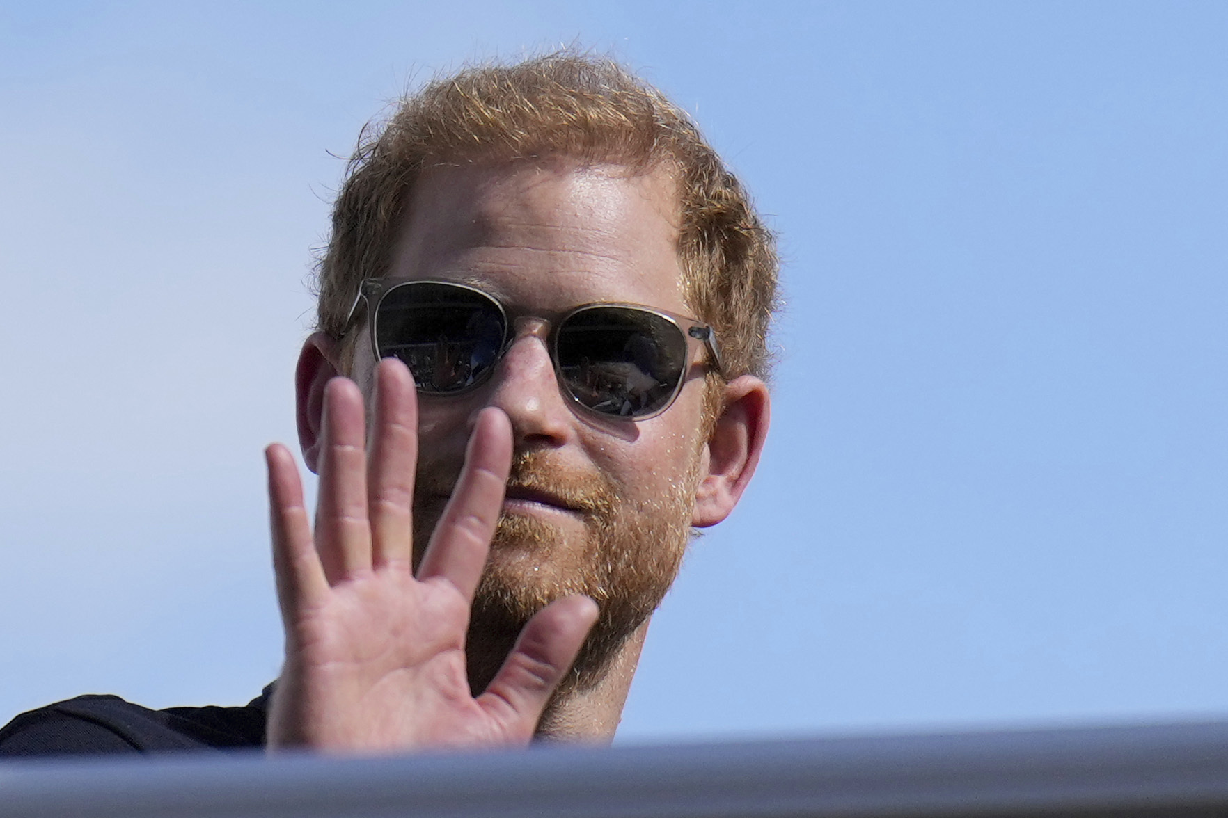 Prince Harry waves during the Formula One U.S. Grand Prix auto race on Oct. 22, 2023, in Austin, Texas.