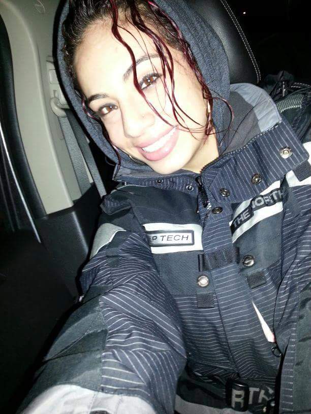 A dark-haired young woman in a black jacket