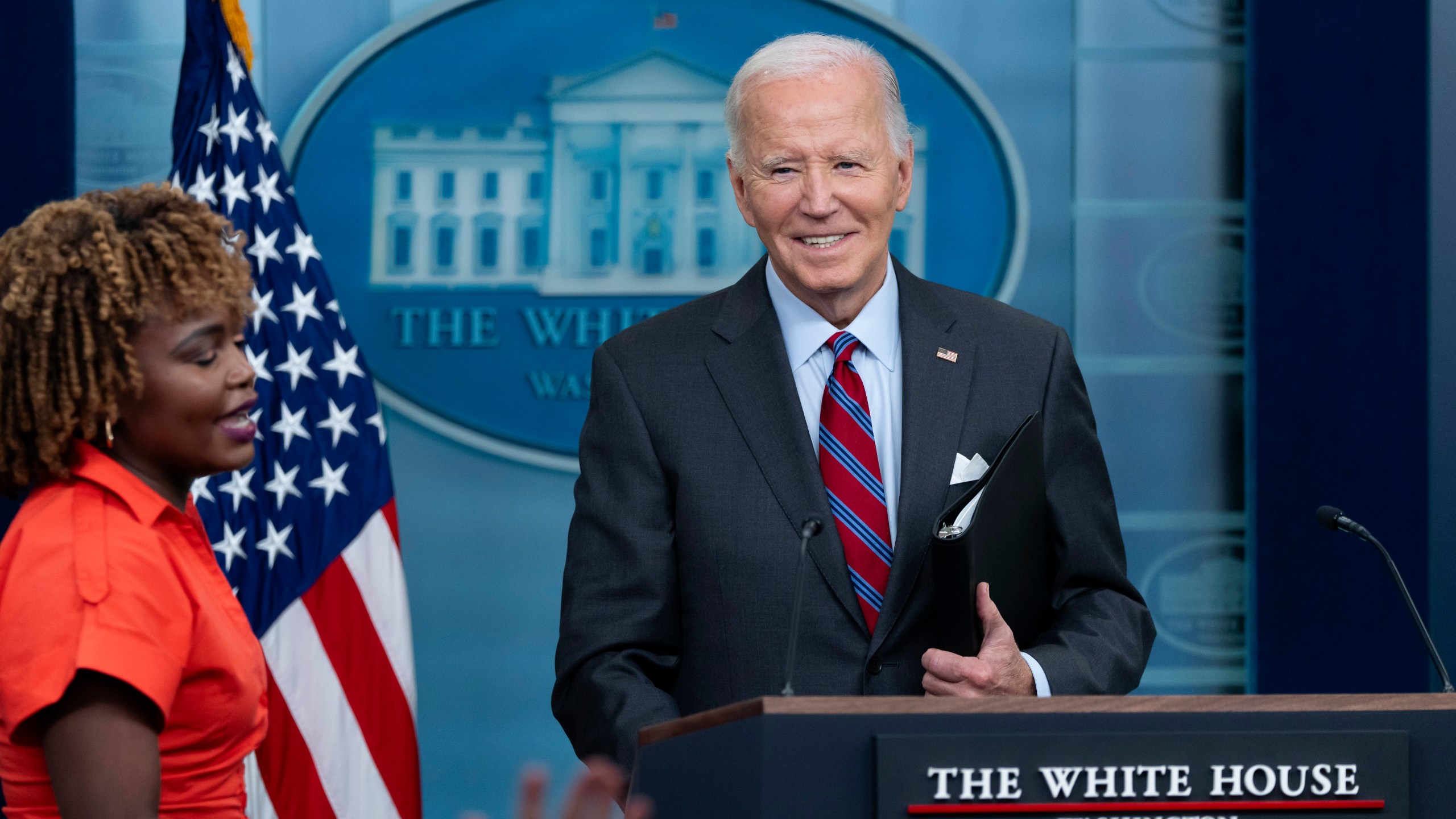 President Joe Biden, accompanied by Press Secretary Karine Jean-Pierre, makes a joke as he speaks at the top of the daily press briefing, Friday, Oct. 4, 2024, at the White House in Washington. (AP Photo/Ben Curtis)