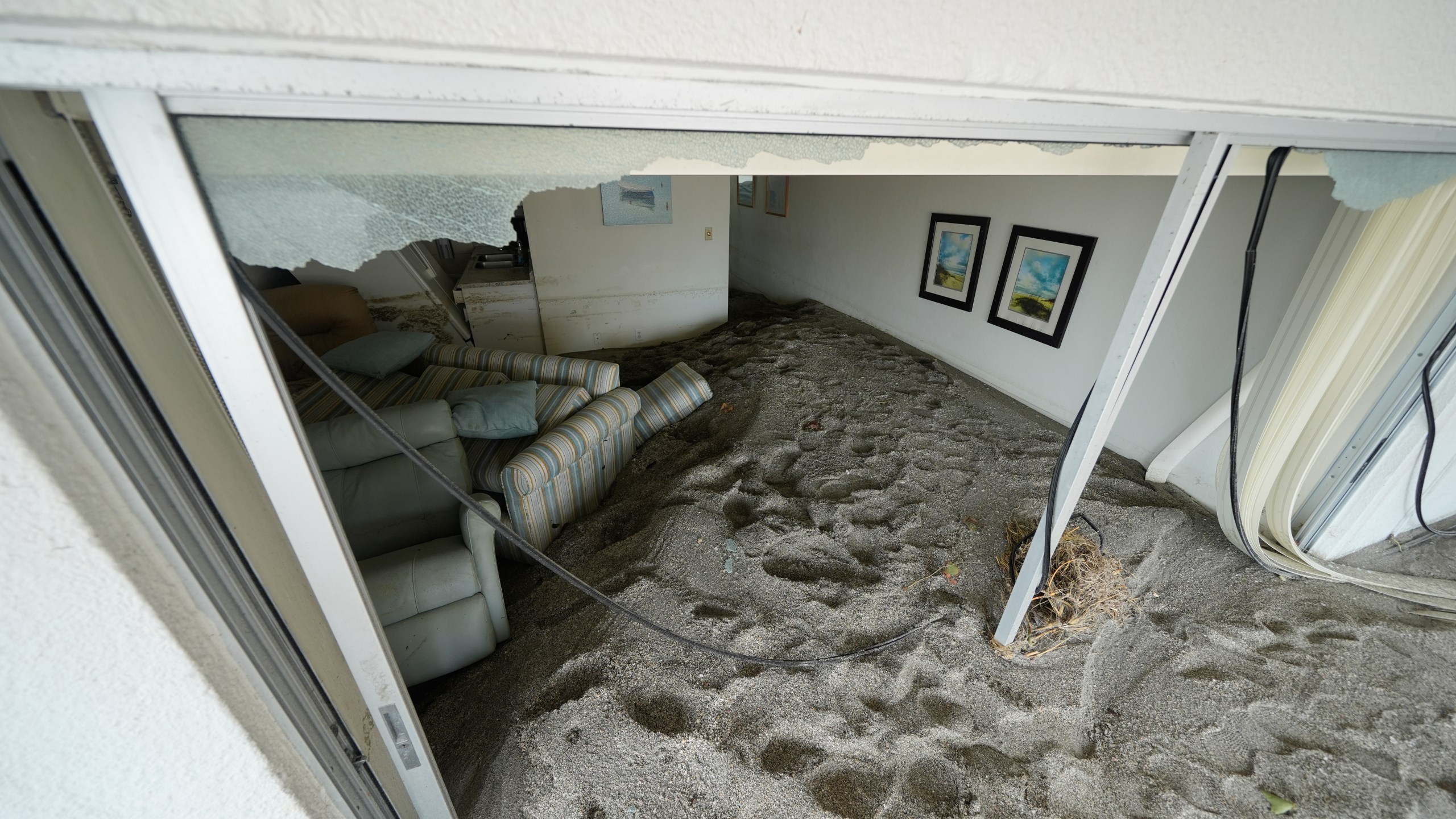 Several feet of sand fills a condo following the passage of Hurricane Milton, at YCA Vacation Rentals in Venice, Fla., Friday, Oct. 11, 2024. (AP Photo/Rebecca Blackwell)