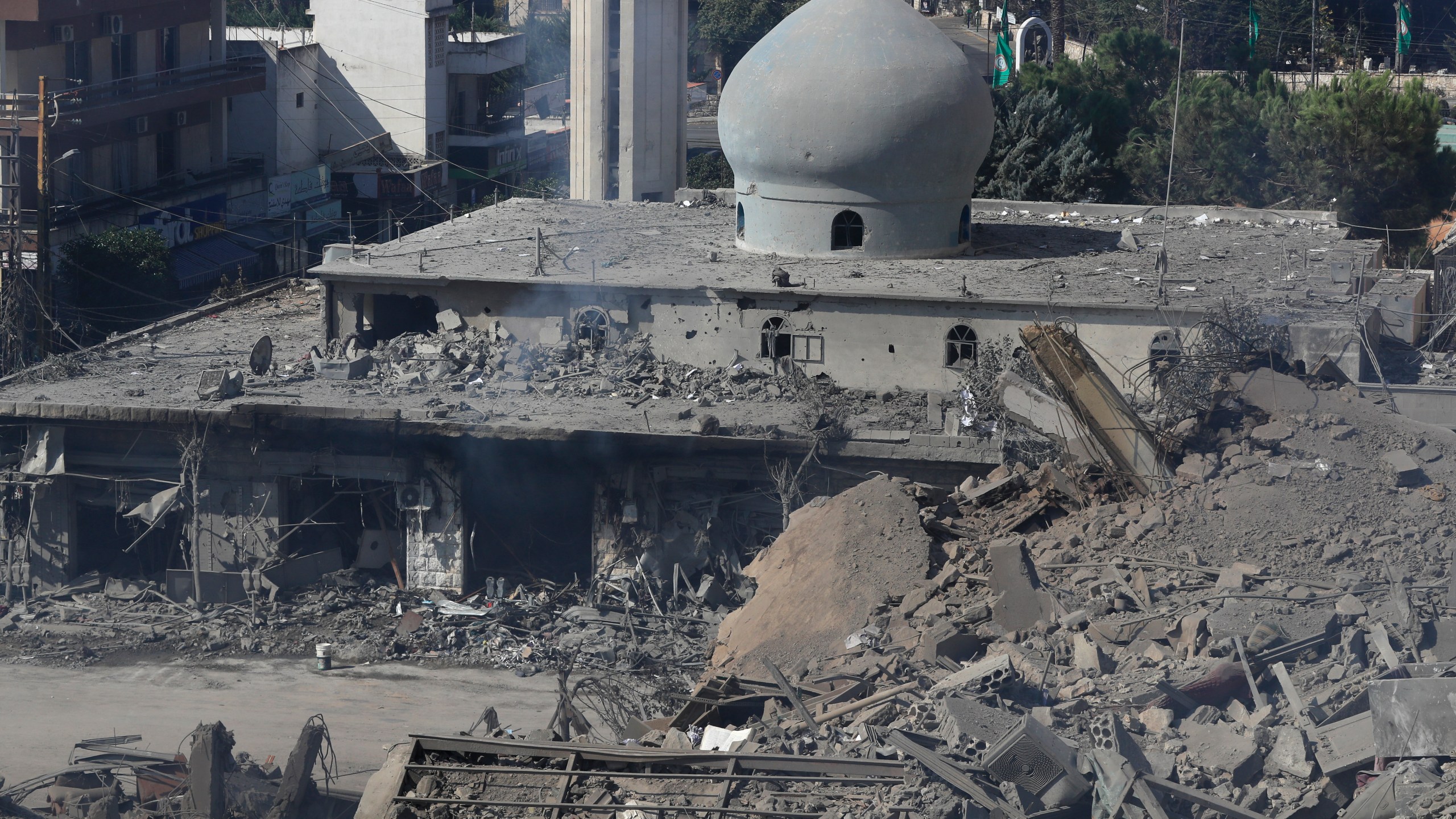 Destroyed shops and a mosque are seen on a commercial street that was hit Saturday night by Israeli airstrikes, in Nabatiyeh town, south Lebanon, Sunday, Oct. 13, 2024. (AP Photo/Mohammed Zaatari)