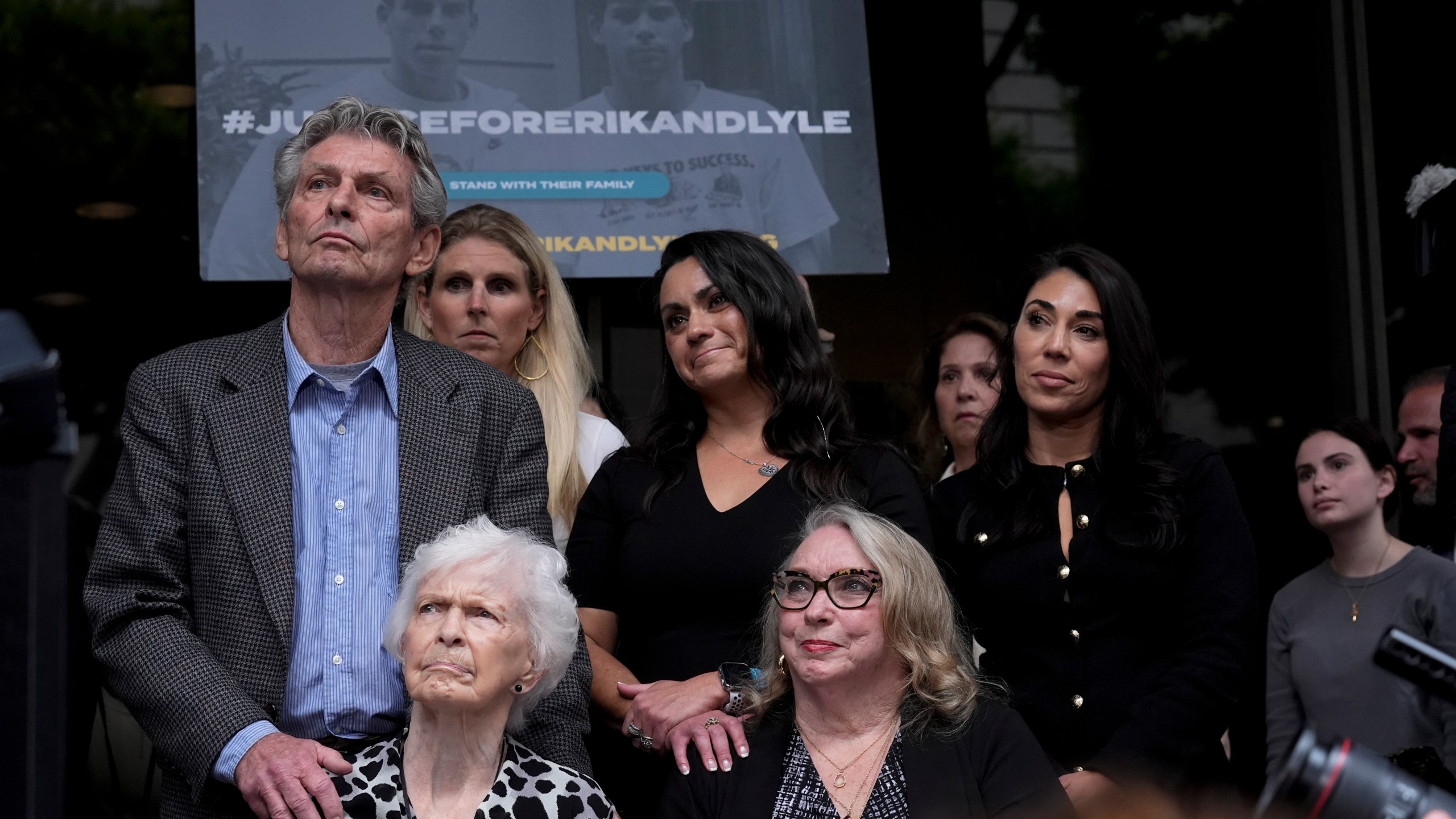 Kitty Menendez' sister, Joan Andersen VanderMolen, bottom left, and niece Karen VanderMolen, right, sit together during a press conference to announce developments on the case of brothers Erik and Lyle Menendez, Wednesday, Oct. 16, 2024, in Los Angeles. (AP Photo/Damian Dovarganes)