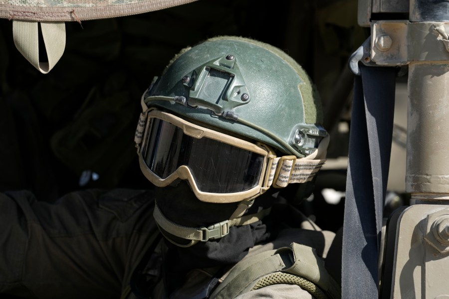 An Israeli soldier drives in a vehicle on the Israel-Gaza border, as seen from southern Israel, Friday, Oct. 18, 2024. (AP Photo/Tsafrir Abayov)