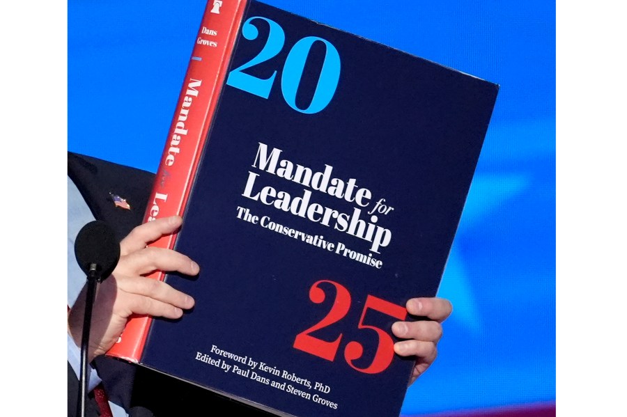 A copy of Project 2025 is held during the Democratic National Convention, Aug. 21, 2024, in Chicago. For a year, Project 2025 has endured as a persistent force in the presidential election. It’s rare for a complex 900-page policy book to figure so dominantly in a political campaign. (AP Photo/J. Scott Applewhite)