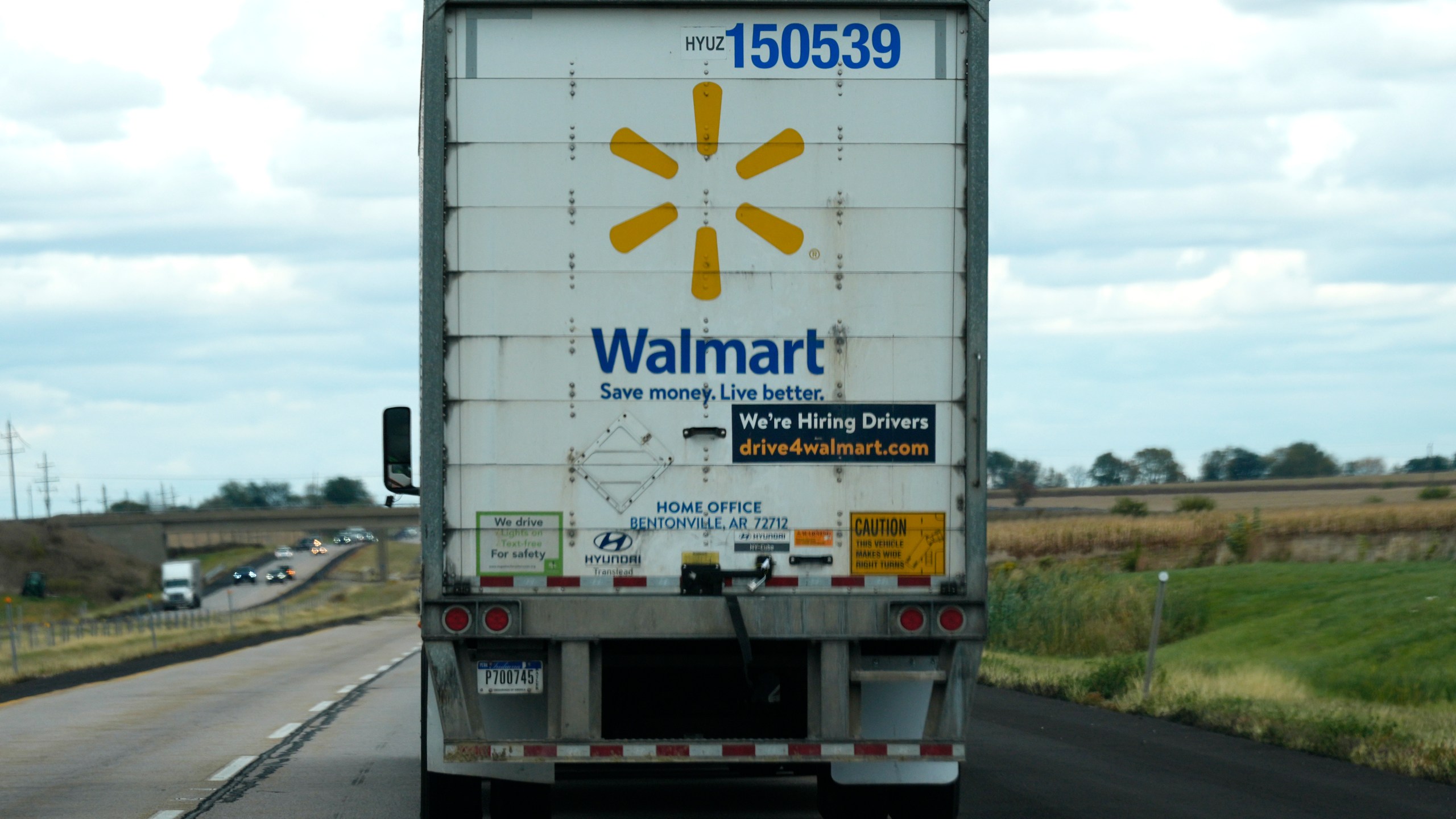 The Walmart truck fleet has We're Hiring Drivers signage on the back of the truck on I-88 road in Franklin Grove, Ill., Monday, Oct. 14, 2024. (AP Photo/Nam Y. Huh)
