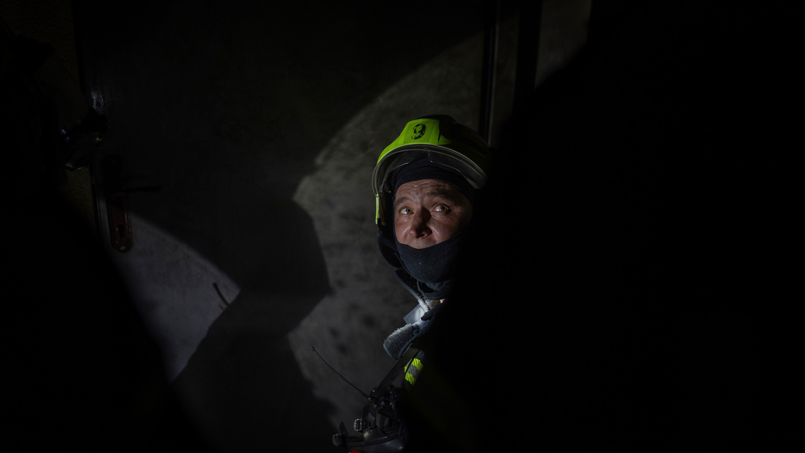A firefighter looks on from a floor that burned down after a Russian attack killed a teenager in Kyiv, Ukraine, Friday, Oct. 25, 2024. (AP Photo/Alex Babenko)