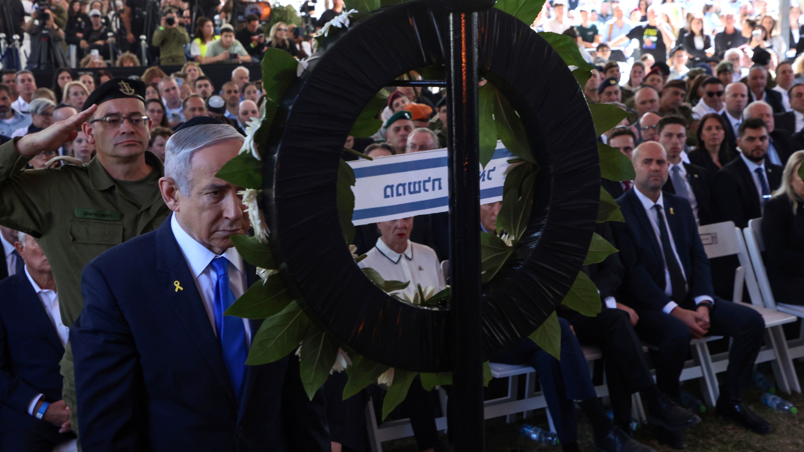Israel's Prime Minister Benjamin Netanyahu takes part in a ceremony marking the Hebrew calendar anniversary of the Hamas attack on October 7 last year that sparked the ongoing war in Gaza, at the Mount Herzl military cemetery in Jerusalem, Israel Sunday Oct. 27, 2024. (Gil Cohen-Magen/Pool Photo via AP)