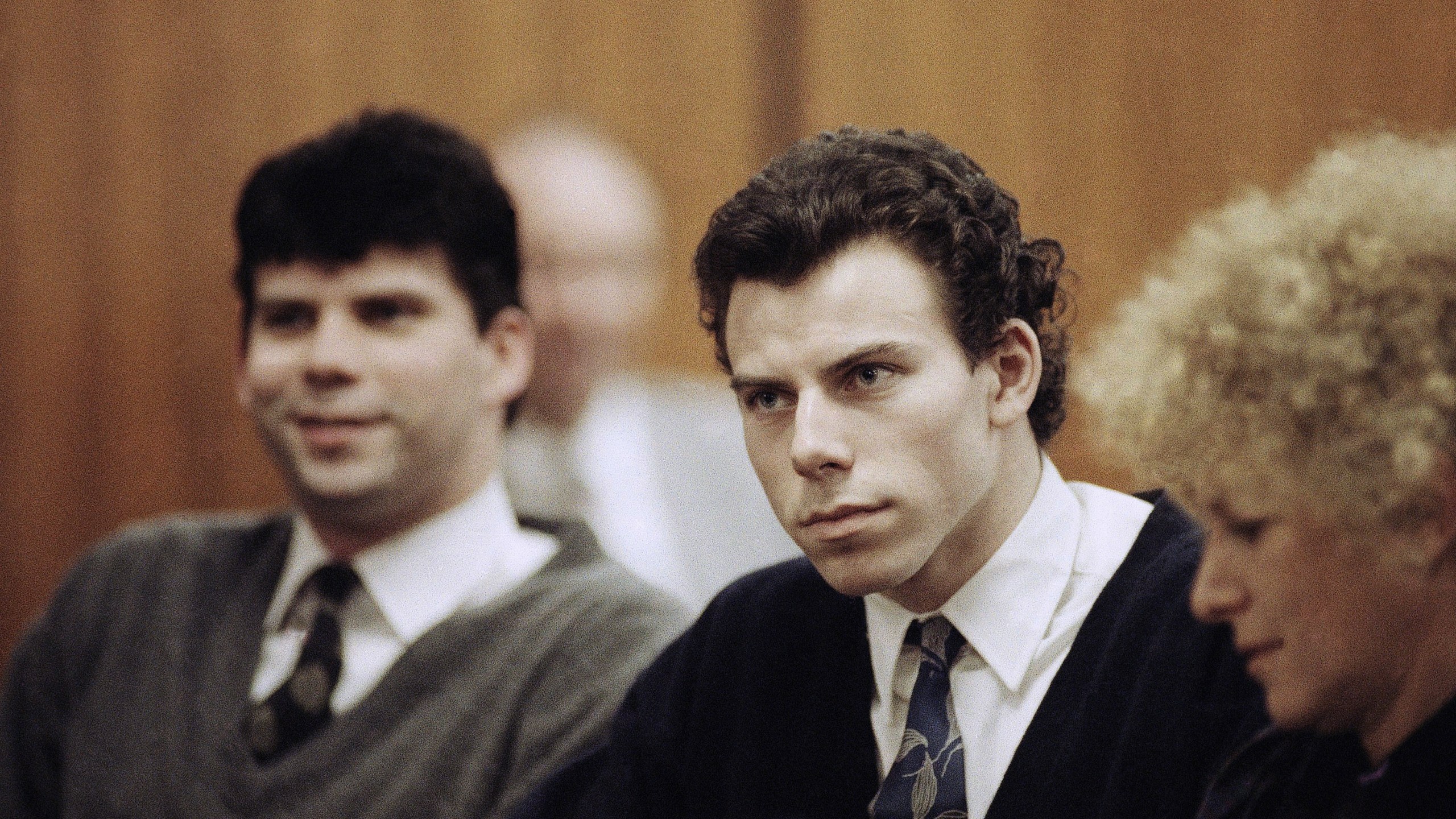 Lyle, left, and Erik Menendez sit with defense attorney Leslie Abramson, right, in Beverly Hills Municipal Court during a 1990 hearing.