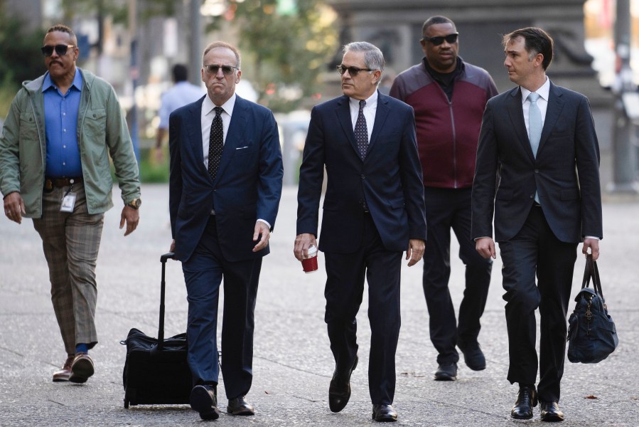 Philadelphia District Attorney Larry Krasner, third from right, arrives for a hearing at a City Hall courtroom.