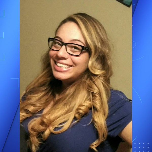A woman with blond hair and black glasses.