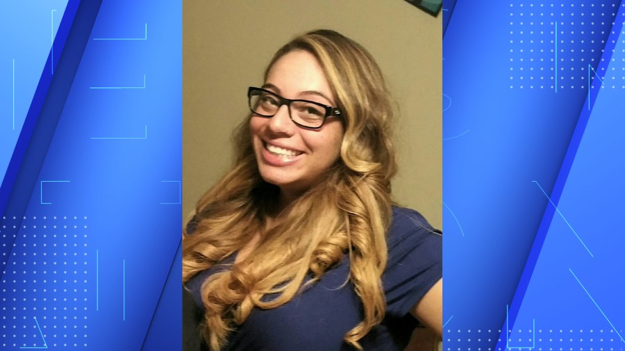 A woman with blond hair and black glasses.