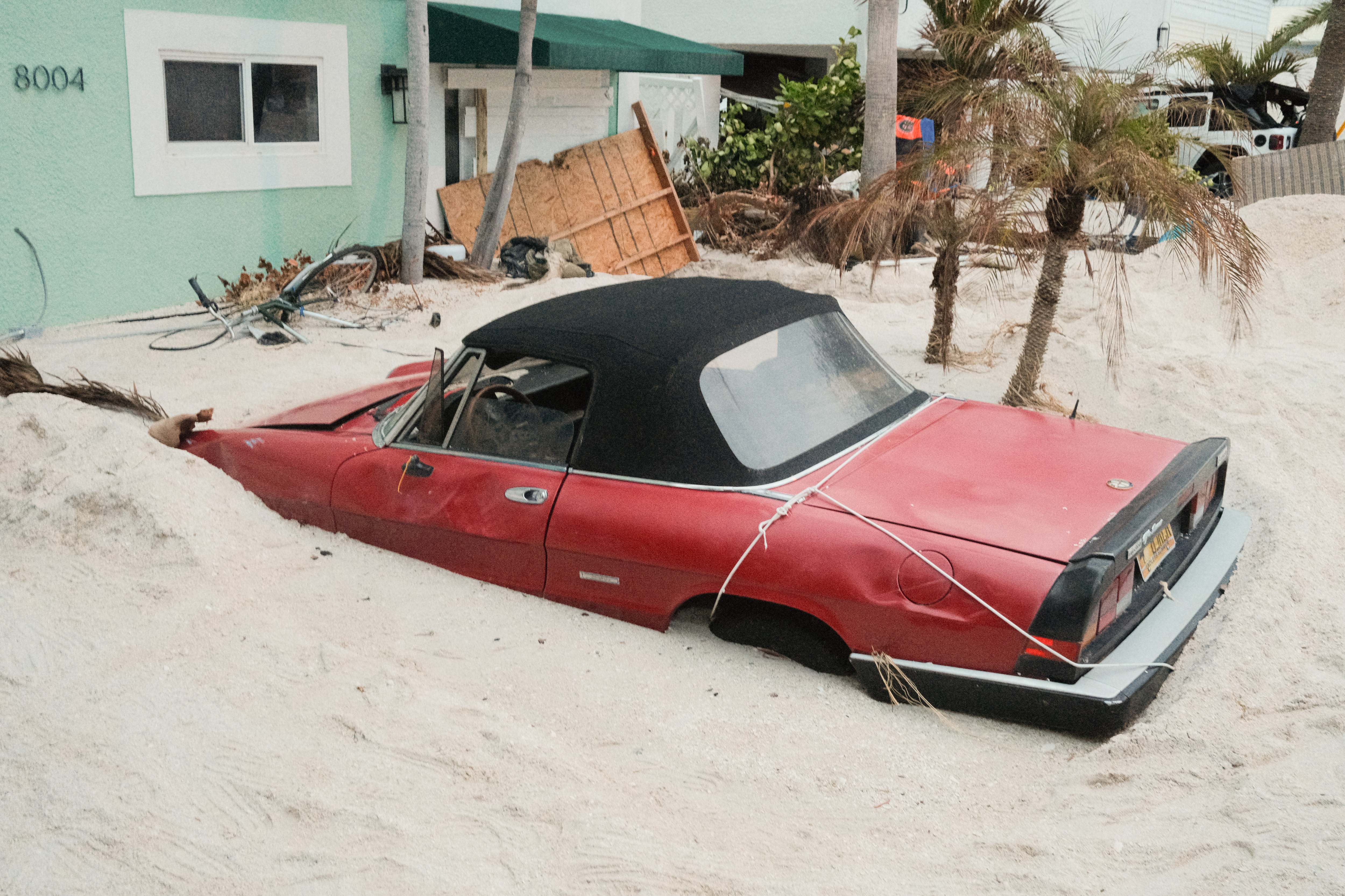 A vehicle stuck in sand after Hurricane Helene.