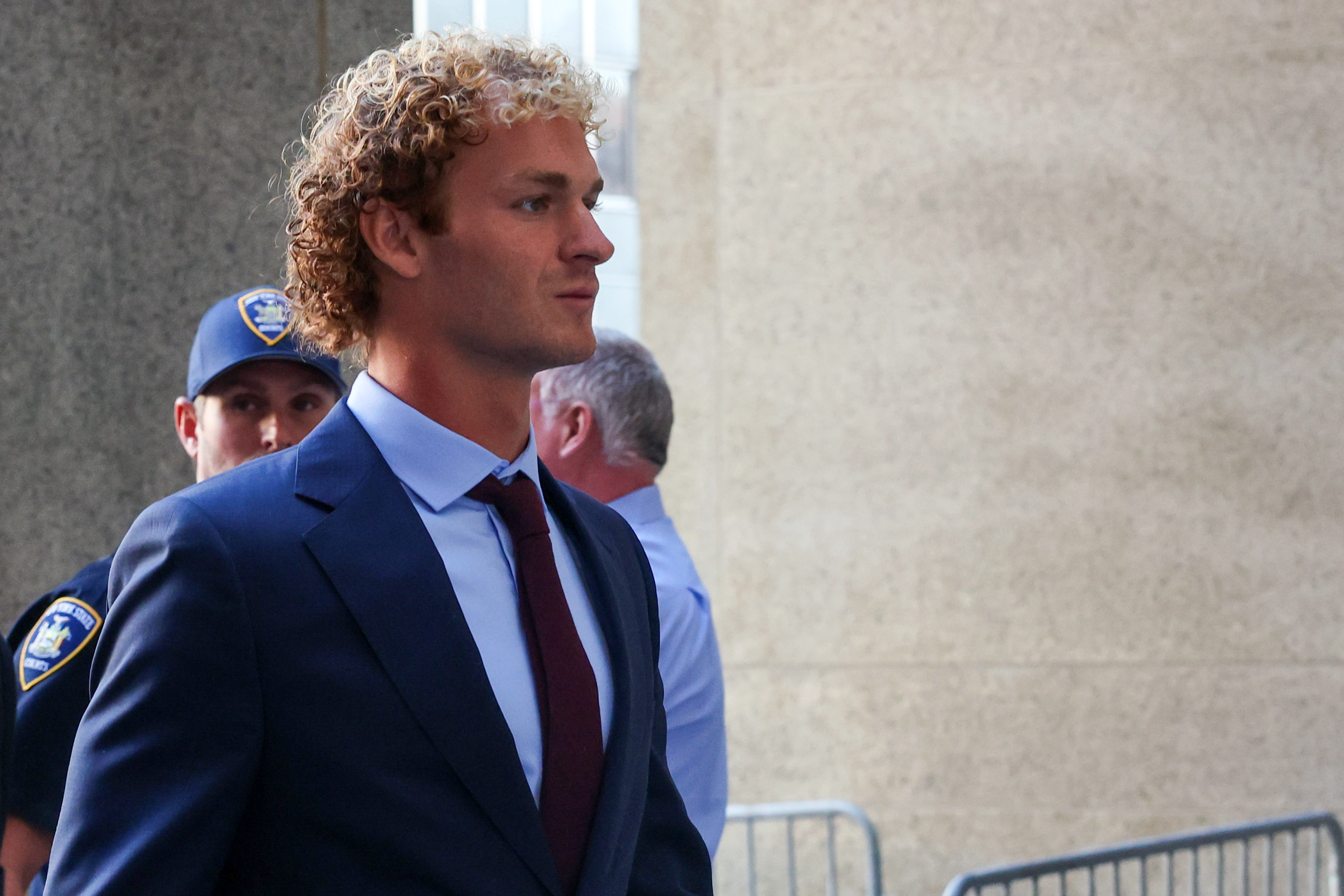 Daniel Penny walks into the courthouse as jury selection begins in his trial.