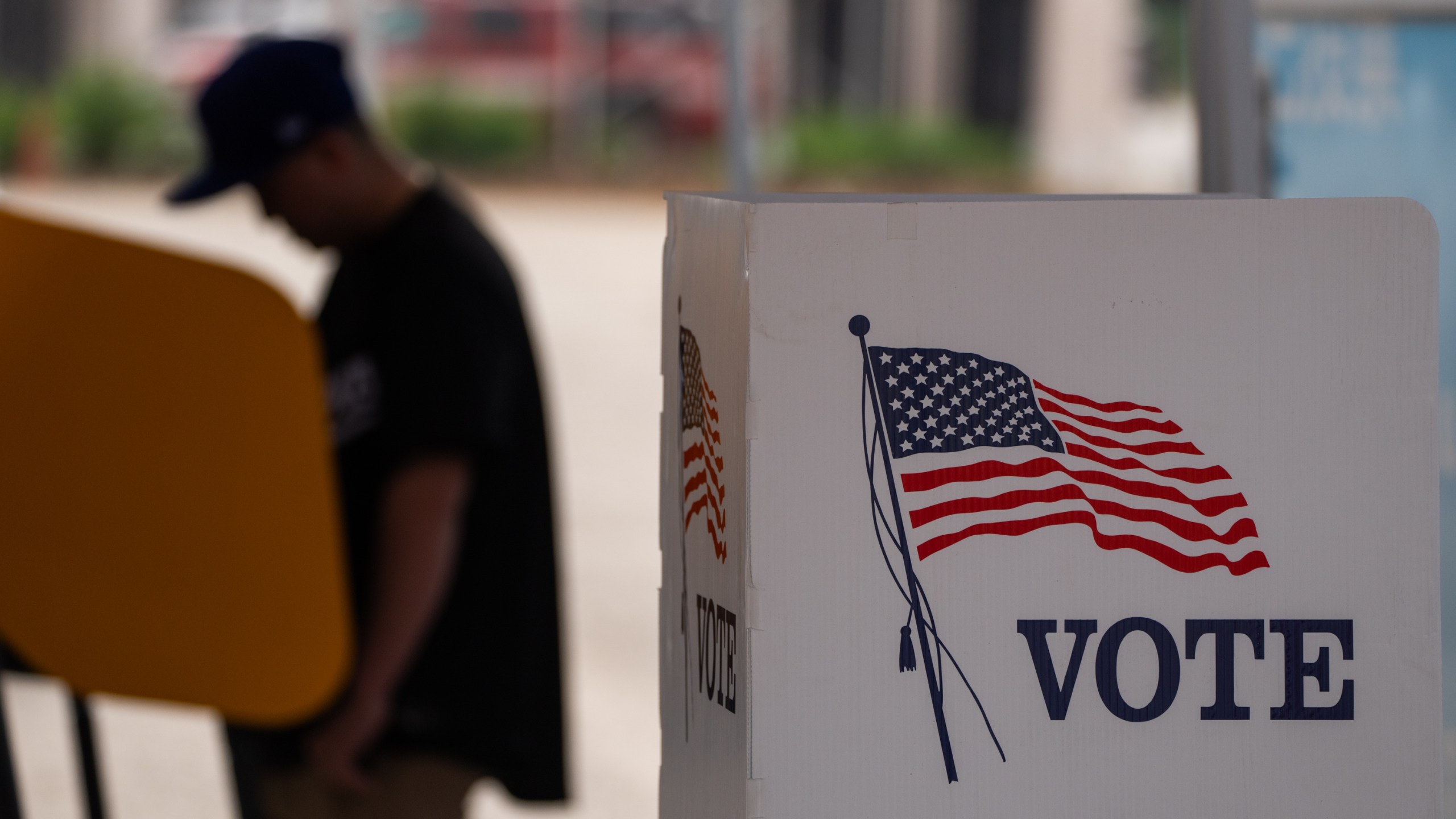 A voter casts ballot during the early voting process at a polling station in California.