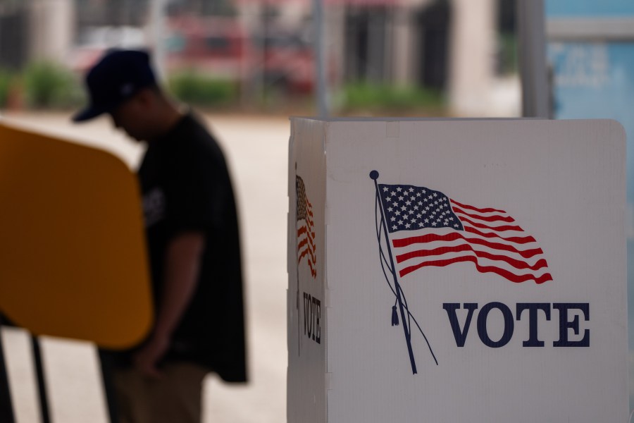 A voter casts ballot during the early voting process at a polling station in California.