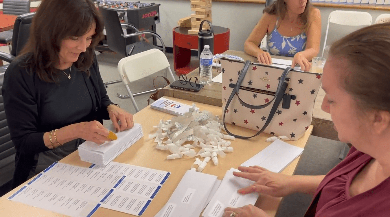New Jersey Republican volunteers are pictured sealing envelopes.