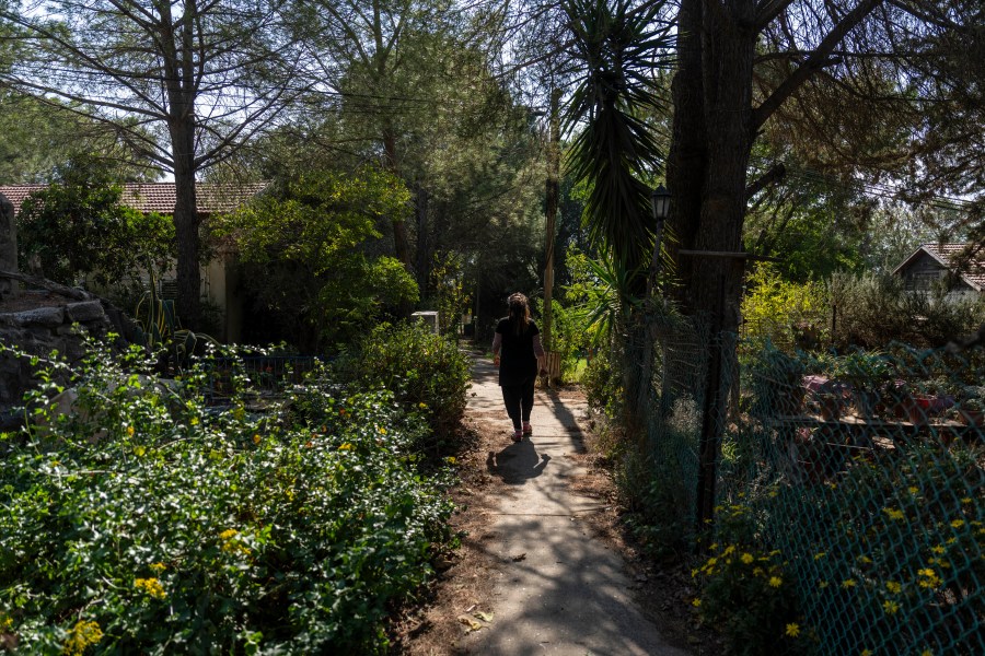 A woman walks in the tiny settlement of "Trump Heights" in the Israeli-controlled Golan Heights, where residents are welcoming the election of their namesake. They hope Donald Trump's return to the U.S. presidency will breathe new life into the community. Thursday, Nov. 7, 2024. (AP Photo/Ariel Schalit)