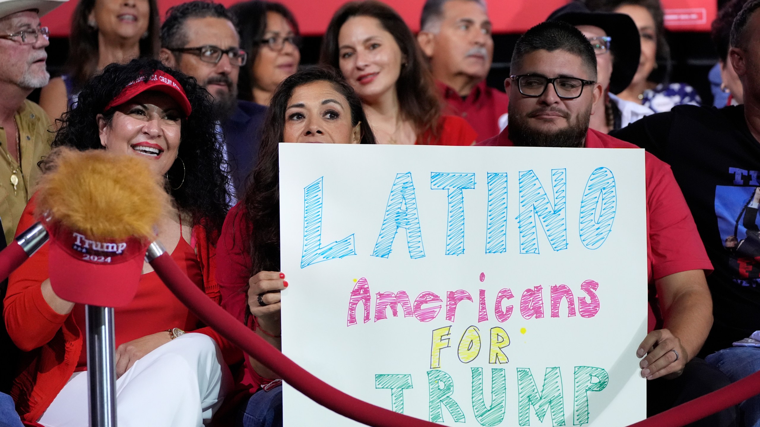 FILE - Supporters hold a sign before Republican presidential nominee former President Donald Trump arrives to speak during a campaign event, Sept.12, 2024, in Tucson, Ariz. (AP Photo/Alex Brandon, File)