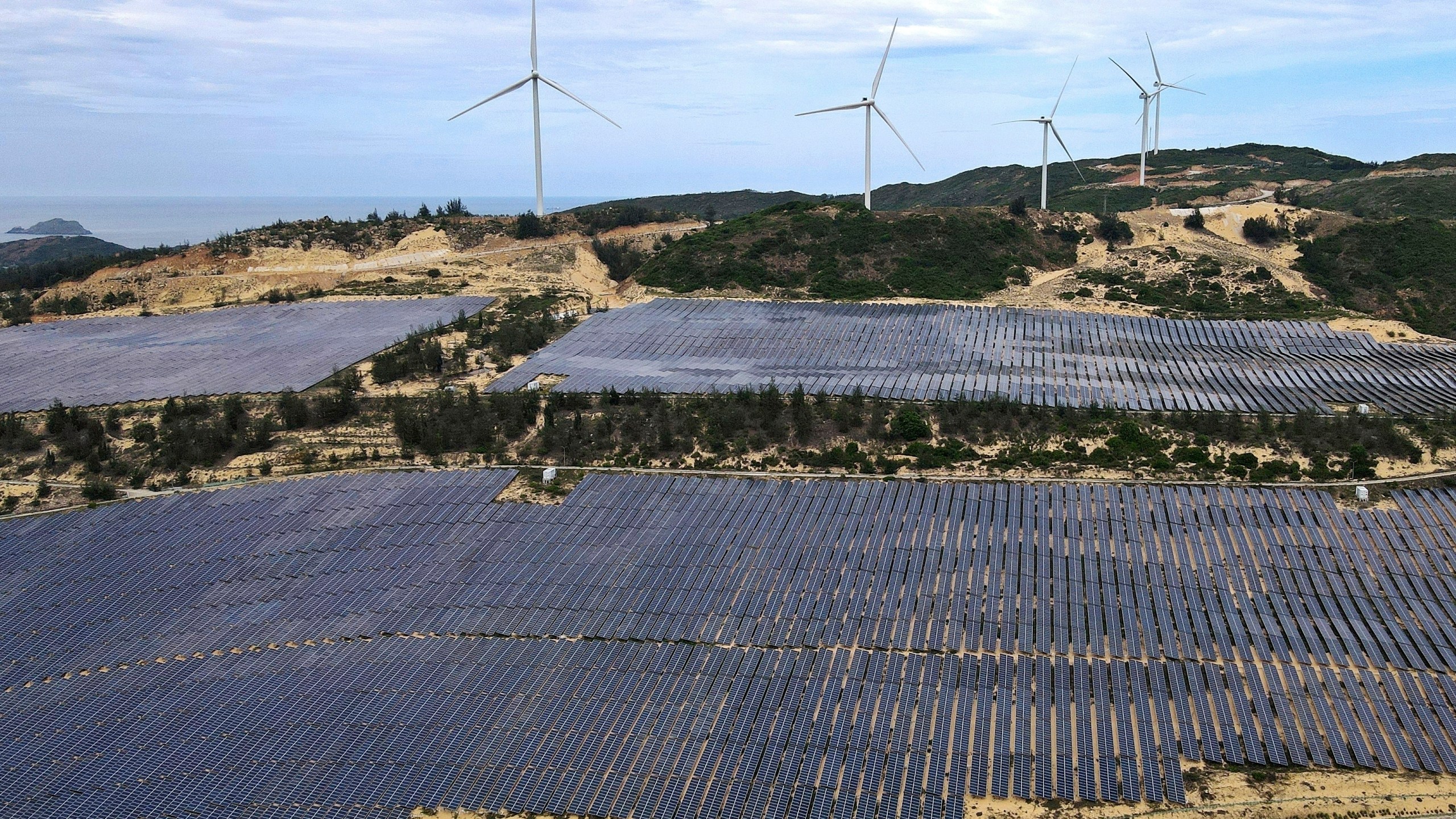 FILE - A solar farm operates near wind turbines in Quy Non, Vietnam on June 11, 2023. (AP Photo/Minh Hoang, File)