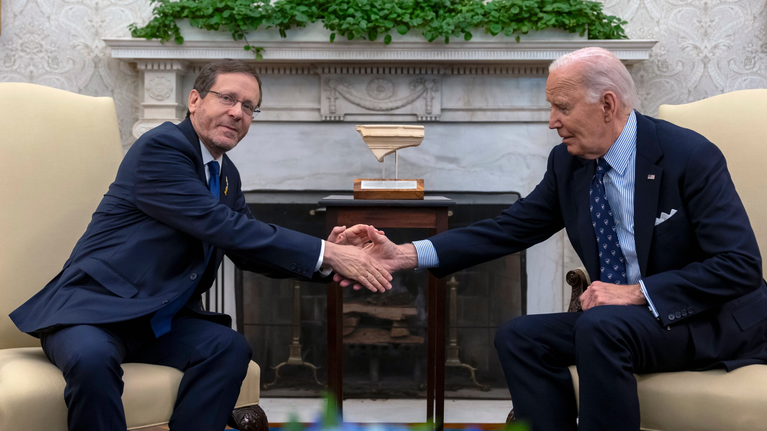 President Joe Biden shakes hands with Israel's President Isaac Herzog, left, during a meeting in the Oval Office of the White House in Washington, Tuesday, Nov. 12, 2024. (AP Photo/Ben Curtis)