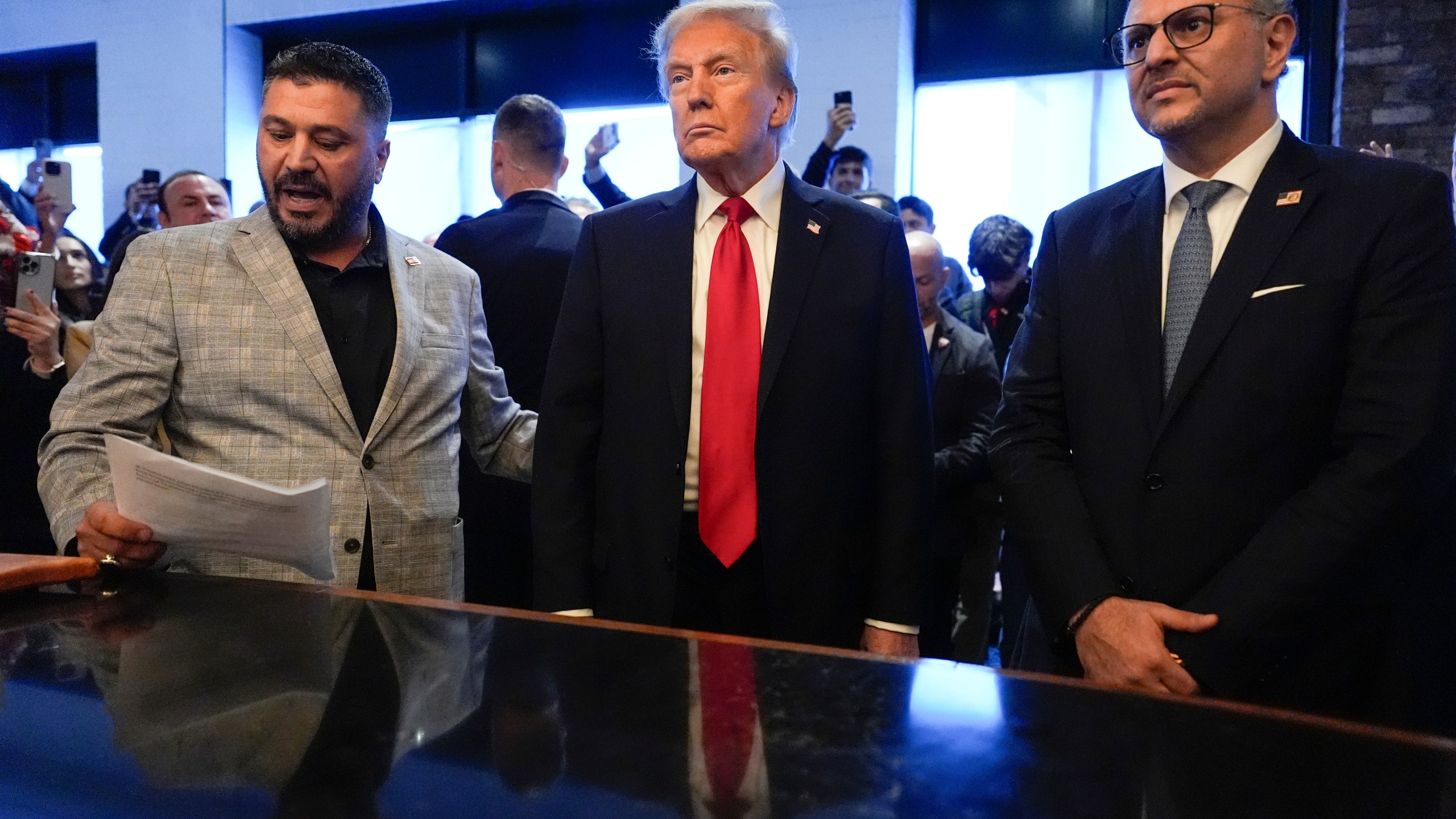 FILE - Republican presidential nominee former President Donald Trump, center, listens to Albert Abbas, owner of The Great Commoner, left, as Massad Boulos looks on during a visit to the cafe, Nov. 1, 2024, in Dearborn, Mich. (AP Photo/Julia Demaree Nikhinson, File)
