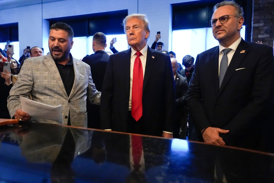 FILE - Republican presidential nominee former President Donald Trump, center, listens to Albert Abbas, owner of The Great Commoner, left, as Massad Boulos looks on during a visit to the cafe, Nov. 1, 2024, in Dearborn, Mich. (AP Photo/Julia Demaree Nikhinson, File)