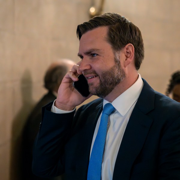 Vice President-elect JD Vance speaks on his mobile phone as he arrives for private meetings at the Capitol in Washington, Wednesday, Nov. 20, 2024. (AP Photo/Ben Curtis)
