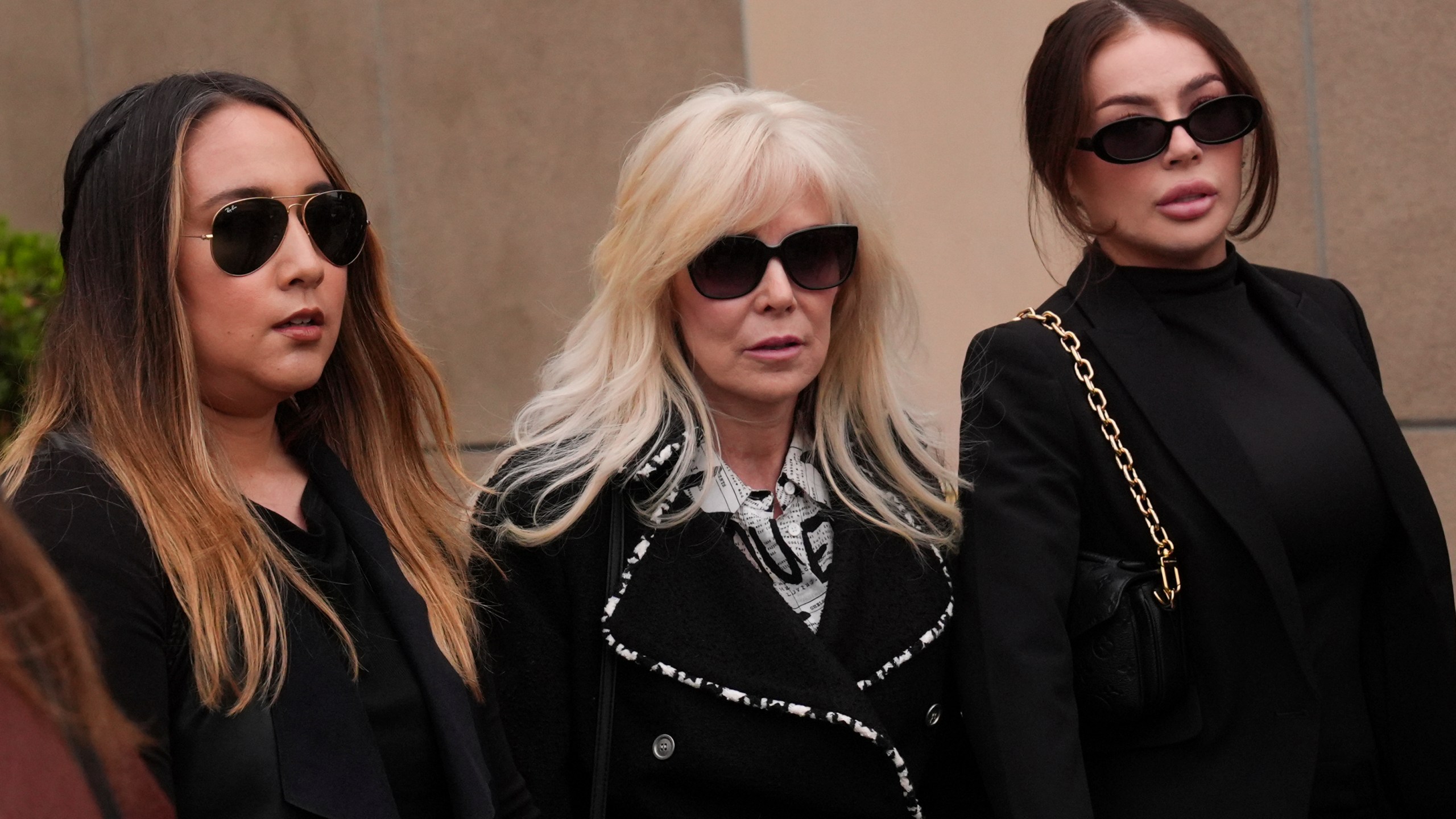 Tammi Menendez, center, the wife of Eric Menendez, leaves a courthouse after a hearing in Los Angeles, Monday, Nov. 25, 2024. (AP Photo/Jae C. Hong)