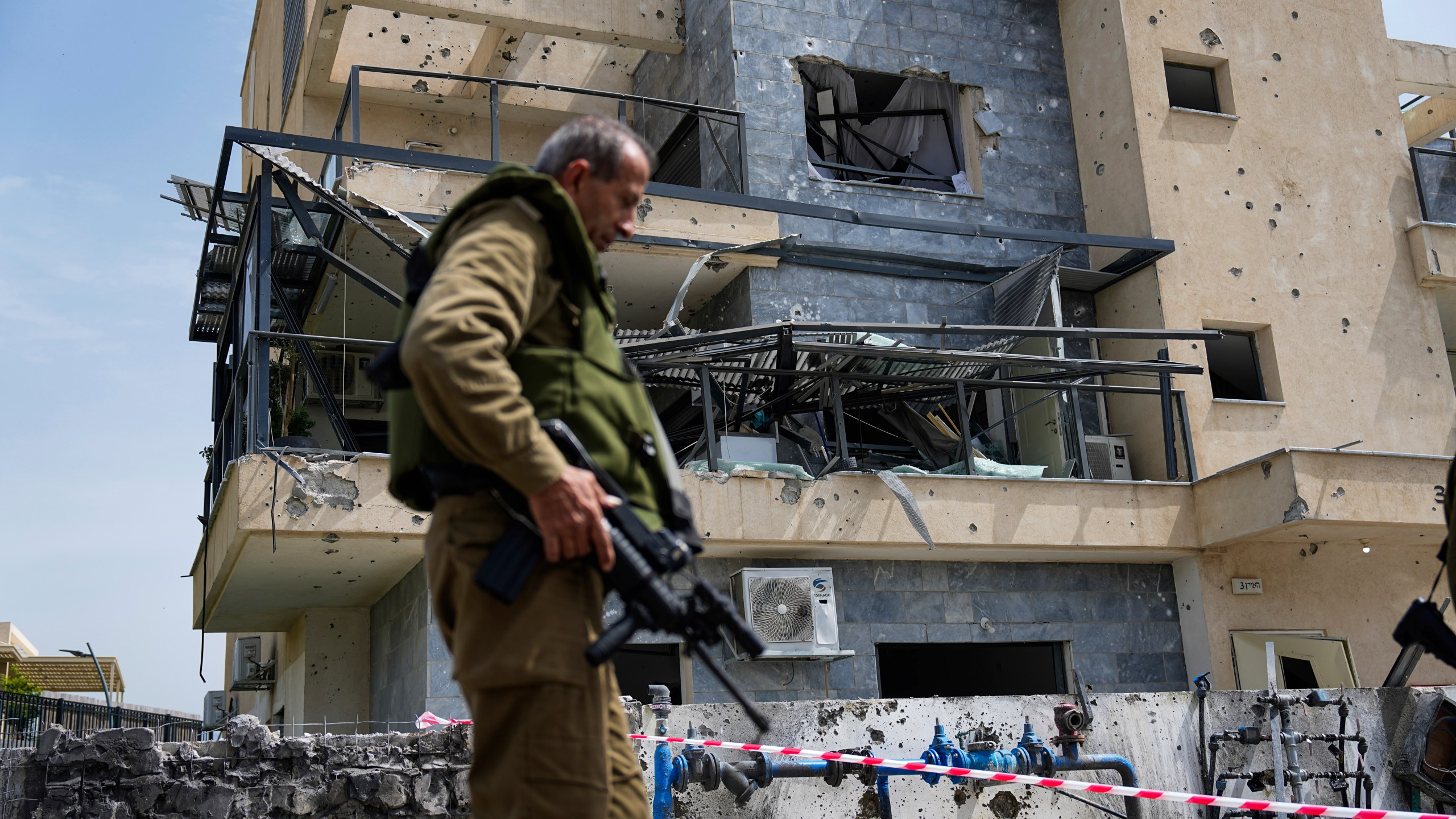 FILE - Israeli security forces examine the site hit by a Hezbollah rocket fired from Lebanon, in Kiryat Shmona, northern Israel, Wednesday, March 27, 2024. (AP Photo/Ariel Schalit, File)