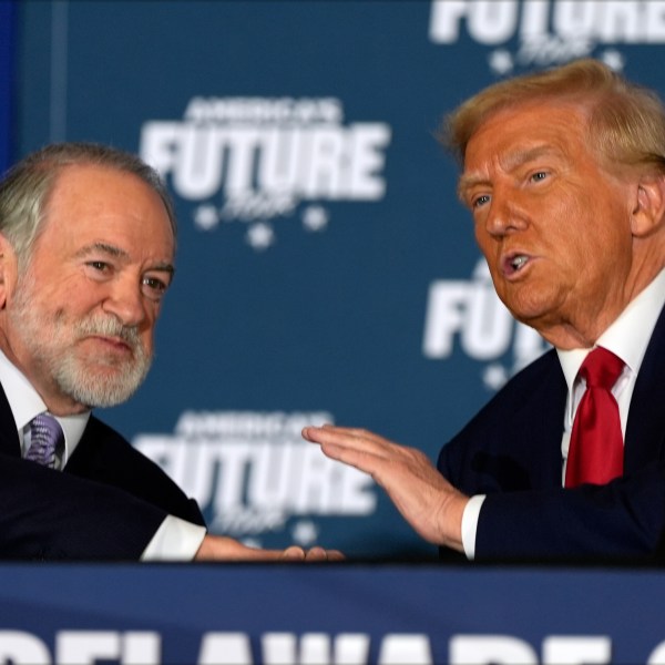 Donald Trump talks with Mike Huckabee Oct. 29, 2024, in Drexel Hill, Pa.