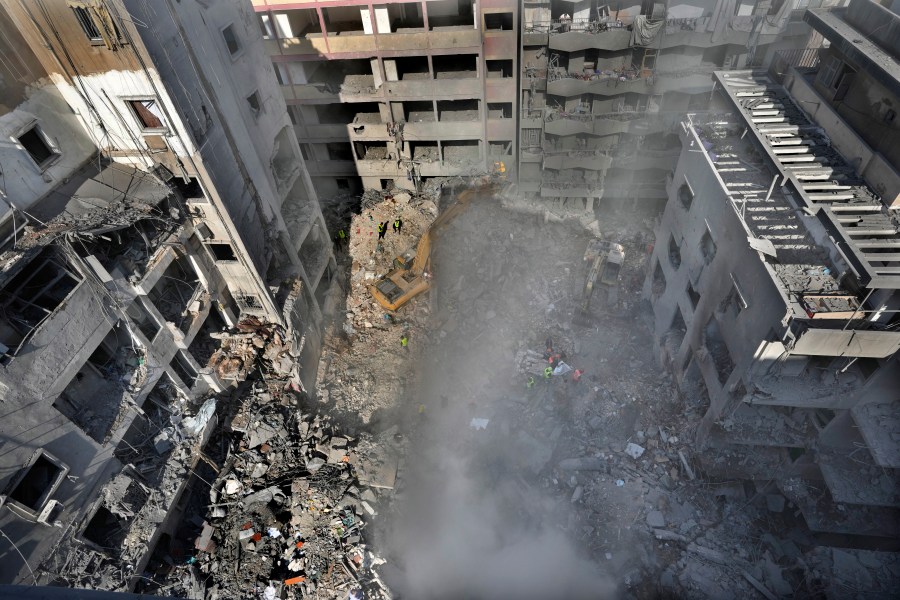 Rescue workers search for victims at the site of an Israeli airstrike that hit central Beirut, Lebanon, Saturday, Nov. 23, 2024.