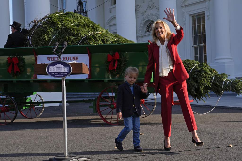 First lady Jill Biden waves as she walks with her grandson Beau Biden.