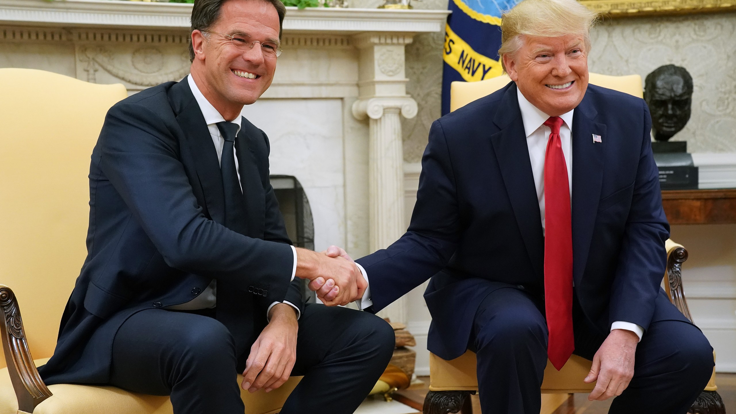 Donald Trump (R) and Nato chief Mark Rutte pose for photographs after talking to reporters in the Oval Office at the White House July 18, 2019 in Washington, DC.