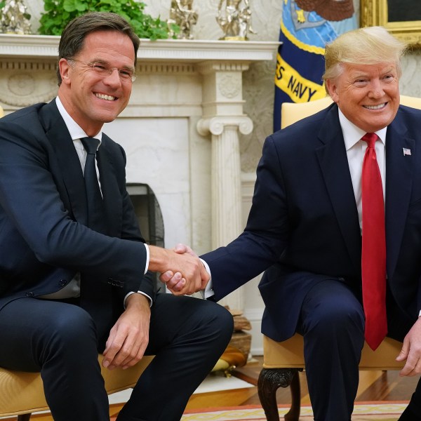 Donald Trump (R) and Nato chief Mark Rutte pose for photographs after talking to reporters in the Oval Office at the White House July 18, 2019 in Washington, DC.