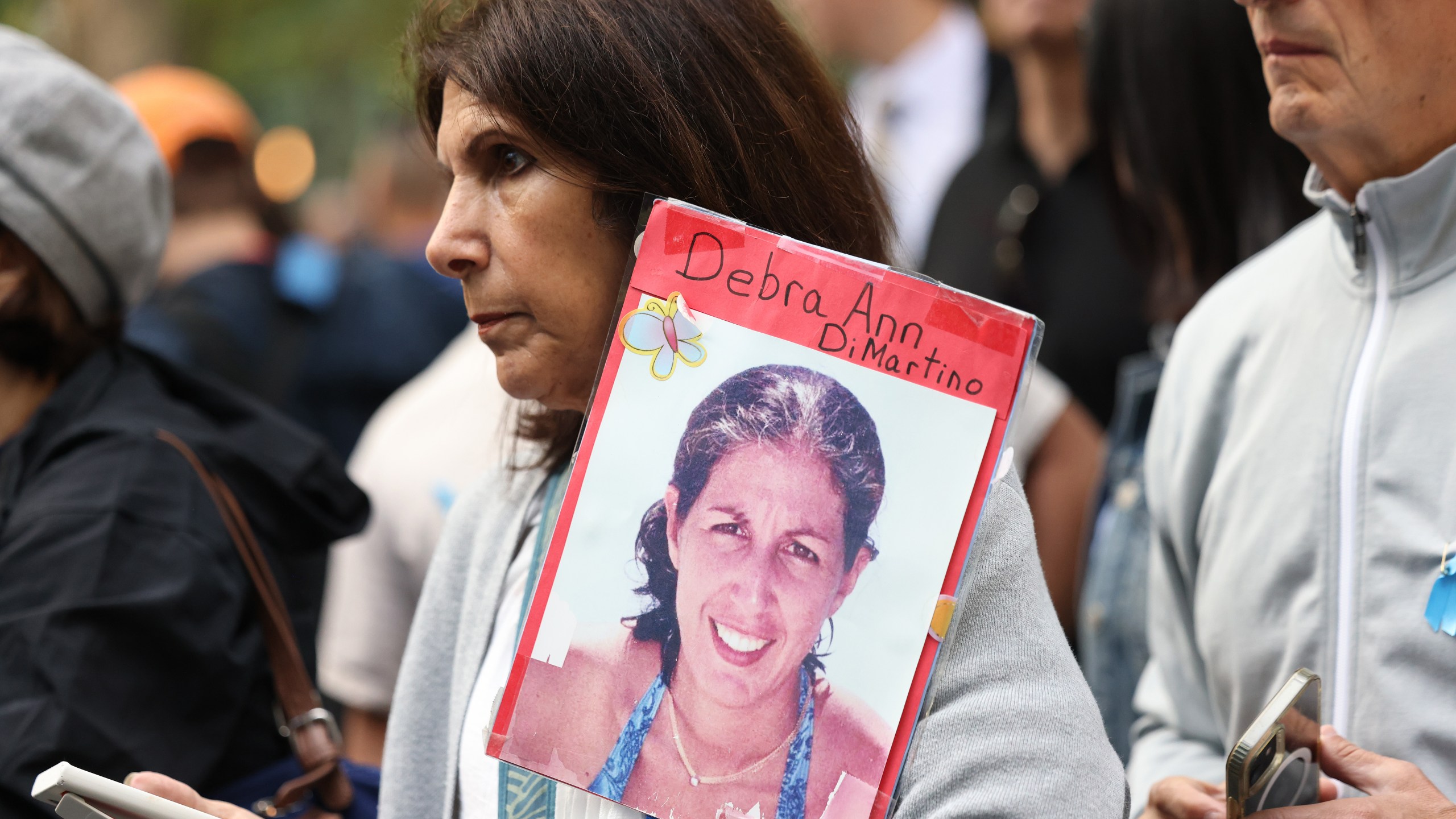 A woman holds a picture of a victim of the 9/11 terror attack at the annual 9/11 Commemoration Ceremony on September 11th, 2024 in New York City.
