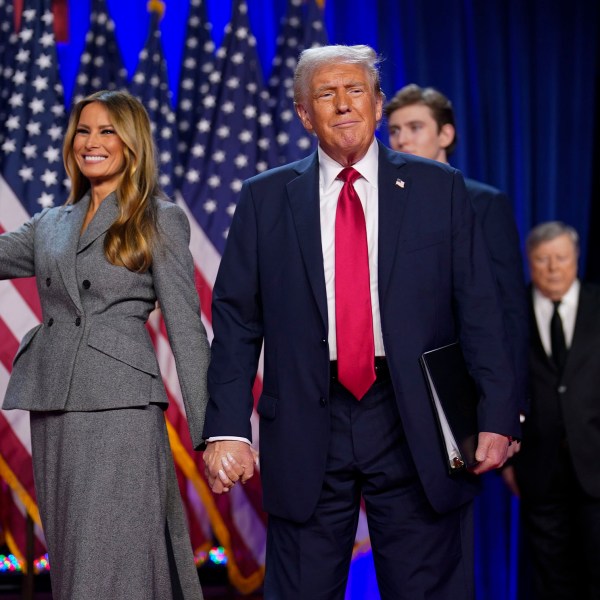 Republican presidential nominee Donald Trump walks out on stage with his wife Melania after being declared the winner during an election night watch party at the Palm Beach County Convention Center in West Palm Beach, FL, on November 6, 2024.
