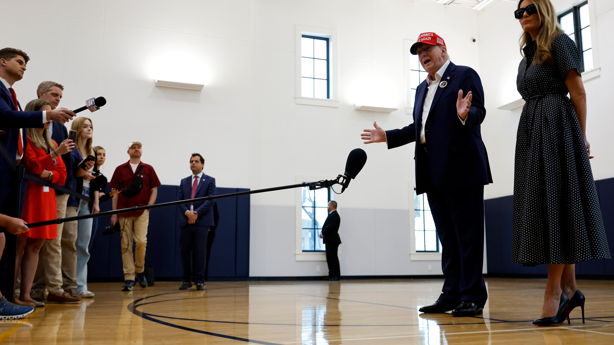 Republican presidential nominee former President Donald Trump and his wife Melania Trump talk to reporters after casting their votes at the polling place in the Morton and Barbara Mandel Recreation Center on Election Day, on November 05, 2024 in Palm Beach, Florida.