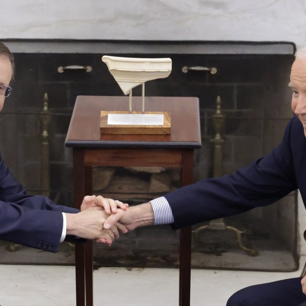 U.S. President Joe Biden shakes the hand of Israeli President Isaac Herzog.