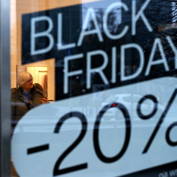 A woman visits a C&A clothing shop promoting Black Friday sales