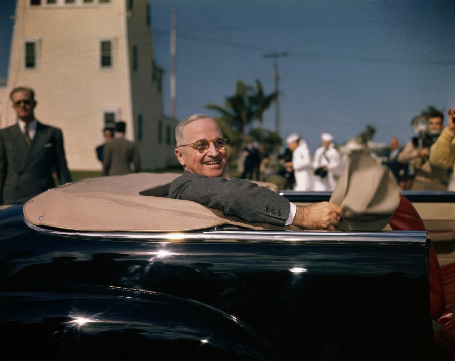 President Harry S. Truman chats from an open-top car in Key West, Florida in 1947.