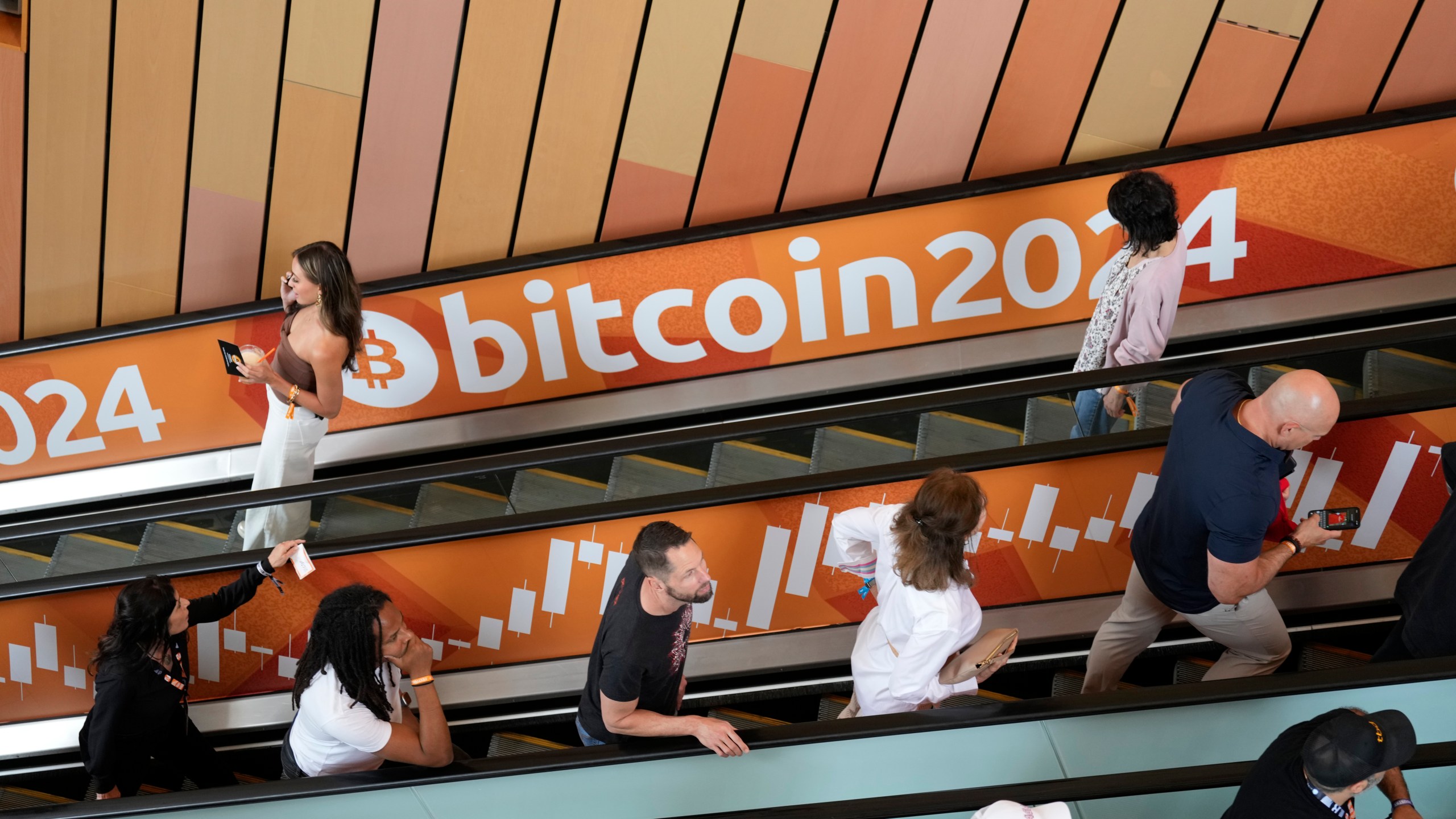FILE - People arrive at the Bitcoin 2024 Conference on July 24, 2024, in Nashville, Tenn. (AP Photo/Mark Humphrey, File)