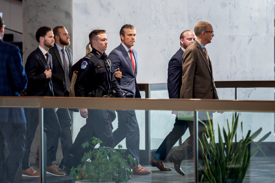 Pete Hegseth, center, President-elect Donald Trump's nominee to be defense secretary, is escorted to meet with Sen. Mike Rounds, R-S.D., a member of the Senate Armed Services Committee, at the Capitol in Washington, Thursday, Dec. 5, 2024. (AP Photo/J. Scott Applewhite)