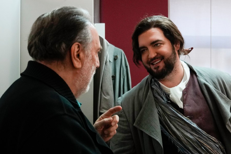 American tenor Brian Jagde talks with La Scala director Riccardo Chailly in his dressing room before performing in the general rehearsals of Giuseppe Verdi's "La Forza del Destino", opening the season at La Scala Opera House, in Milan, Italy, Thursday, Nov. 28, 2024. (AP Photo/Luca Bruno)