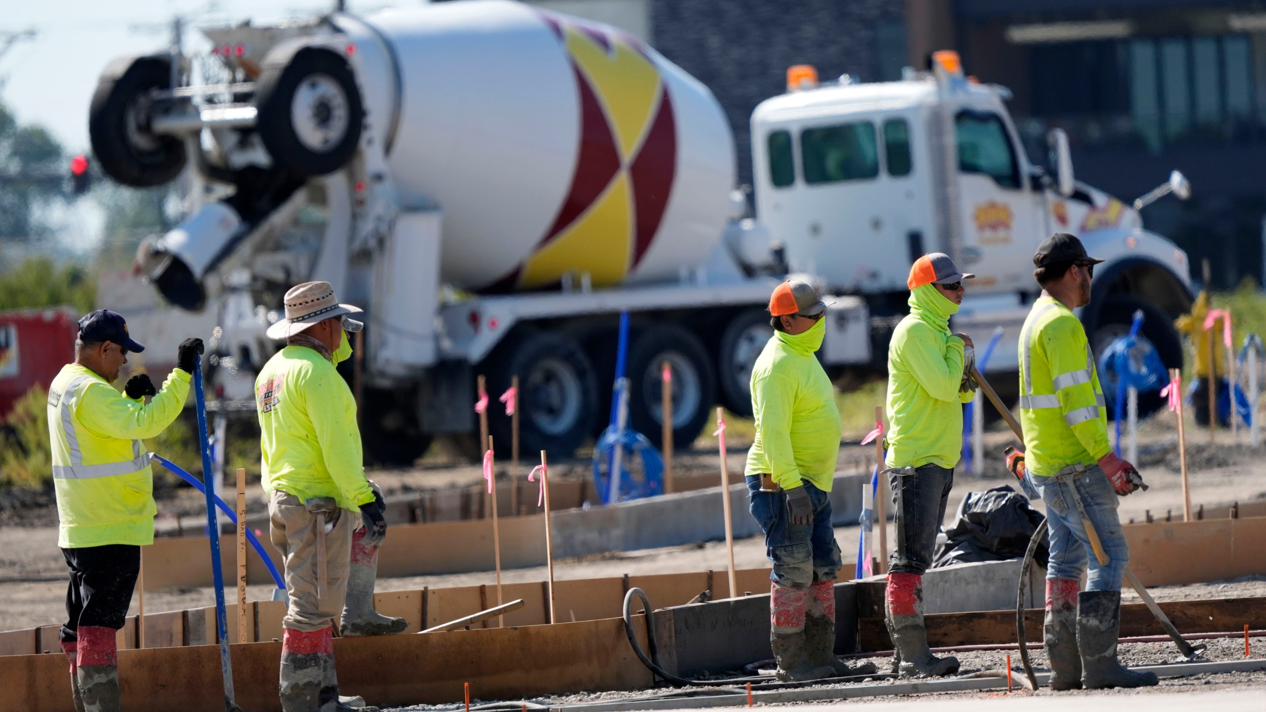 FILE - Construction crew members wait to pour concrete in a parking lot on Sept. 4, 2024, in Waukee, Iowa. (AP Photo/Charlie Neibergall, File)